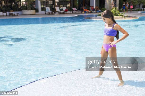 happy child girl jumping to swimming pool - tween girls swimwear stock pictures, royalty-free photos & images