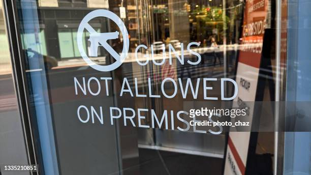 no guns allowed sign at retail store - gun control stock pictures, royalty-free photos & images