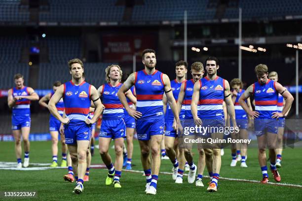 The Bulldogs look dejected following the round 23 AFL match between Western Bulldogs and Port Adelaide Power at Marvel Stadium on August 20, 2021 in...