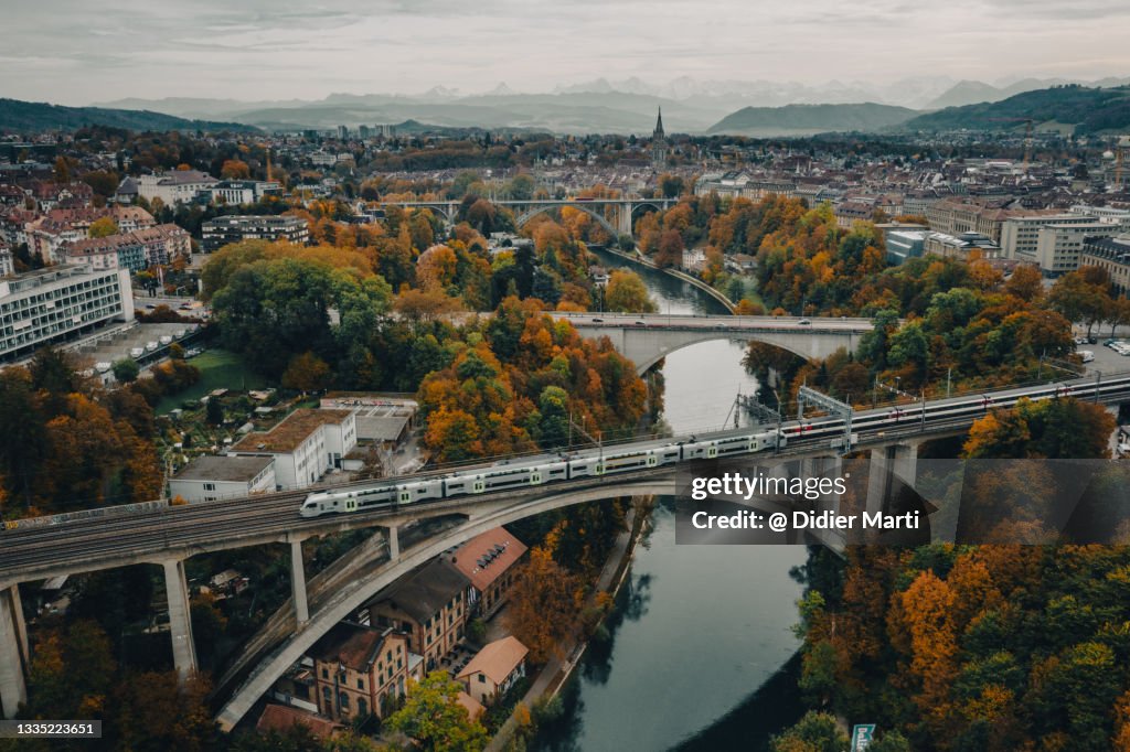 Commuter train on a bridge over the Aar river that flow around Bern old town in Switzerland