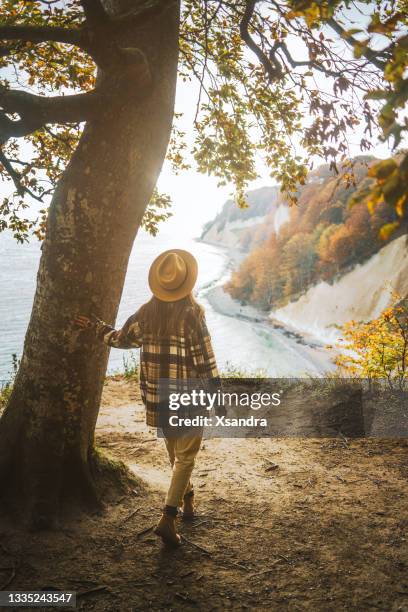 woman enjoying the view at baltic sea - compatibility stock pictures, royalty-free photos & images