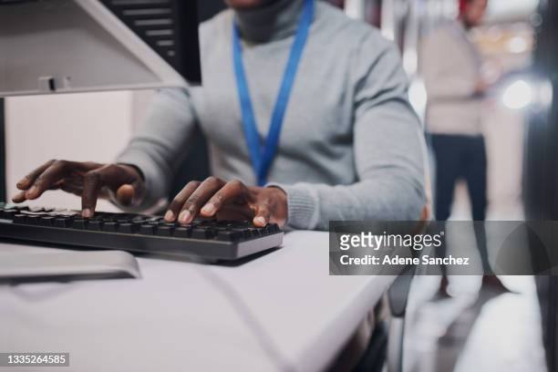 closeup shot of an unrecognisable man working on a computer in a data center - data selective focus stock pictures, royalty-free photos & images