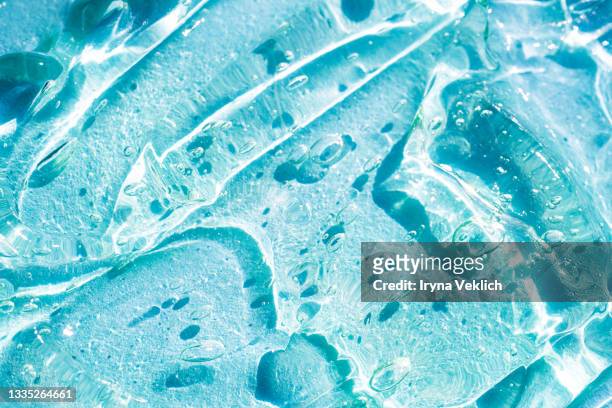 abstract background with moisturizing transparent cosmetic gel or serum for face with oxygen aqua bubbles on blue turquoise color. - refrescante fotografías e imágenes de stock
