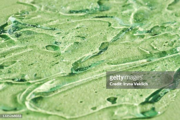 abstract background with aloe vera moisturizing cleaning cosmetic gel or face serum, essential oil with oxygen aqua bubbles on pastel green mint color. - mint green photos et images de collection