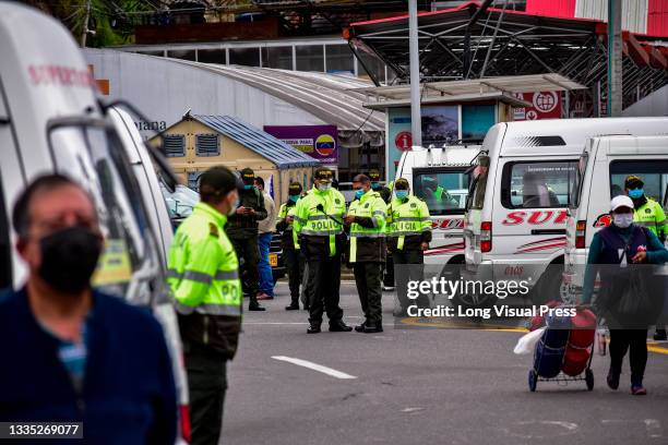 Colombia's police guard protests as drivers of public service vehicles hold protest on the Rumichaca International bridge that conects the countries...