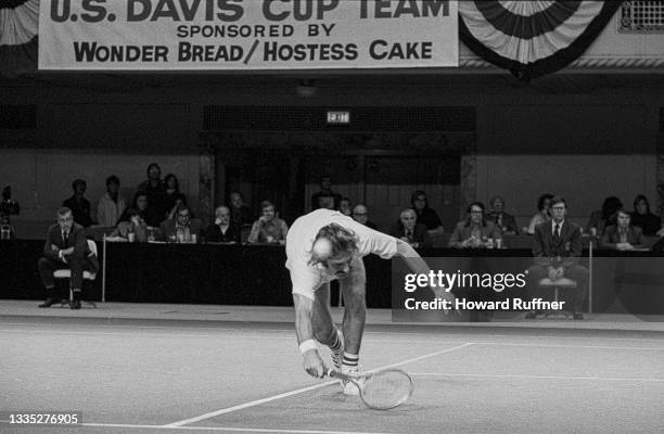 View of Australian tennis player John Newcombe as he reaches forward for a ball during a match on the first day of the 62nd Davis Cup final,...