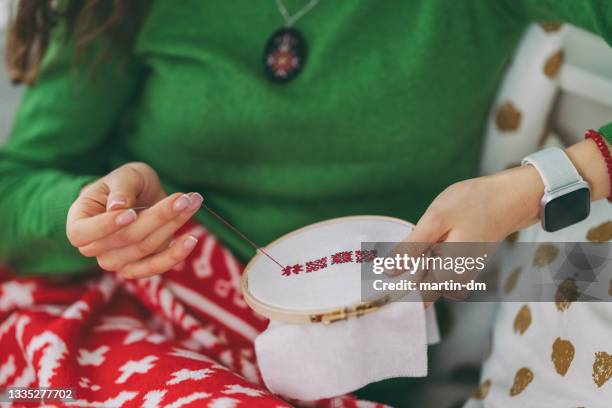 woman embroidering at home - cross stitch stock pictures, royalty-free photos & images