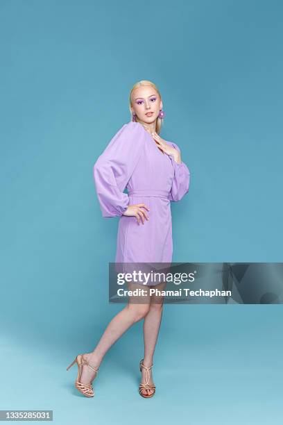 stylish woman in purple in dress - women pastel stock pictures, royalty-free photos & images