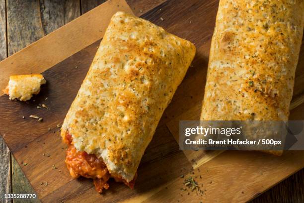 close-up of sandwiches on cutting board - calzone stock-fotos und bilder