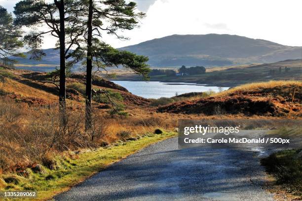 scenic view of road by mountains against sky,loch doon,ayr,united kingdom,uk - ayrshire stock pictures, royalty-free photos & images