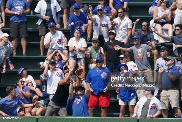 Fans in left field try to catch the home run ball hit by Emmanuel Rivera of the Kansas City Royals during the fifth inning of a game against the...