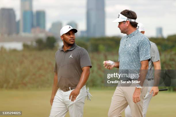 Harold Varner III of the United States talks with Bubba Watson of the United States as they walk off the 14th hole during the second round of THE...