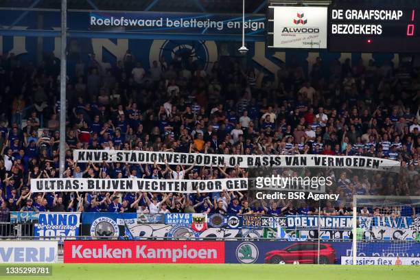 Fans of De Graafschap hold up a banners that read KNVB: stadionverboden op basis van vermoeden, Ultras: blijven vechten voor gerechtigheid! during...