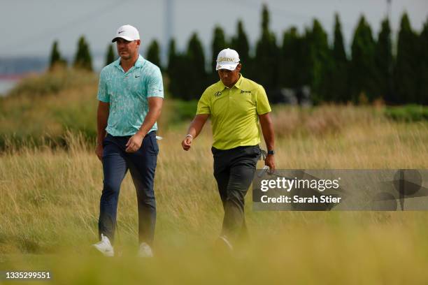 Brooks Koepka of the United States and Hideki Matsuyama of Japan walk to the 14th green during the second round of THE NORTHERN TRUST, the first...