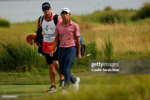 Collin Morikawa of the United States and caddie Jonathan Jakovac walk to the 14th green during the second round of THE NORTHERN TRUST, the first...