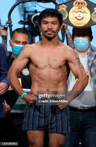 Manny Pacquiao poses on the scale during his official weigh-in at MGM Grand Garden Arena on August 20, 2021 in Las Vegas, Nevada. Pacquiao will...