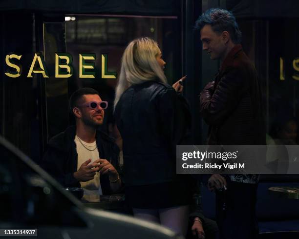 Lottie Moss and Tristan Evans are seen at Isabel Mayfair having a smoke outside with Alex Mytton on August 20, 2021 in London, England.