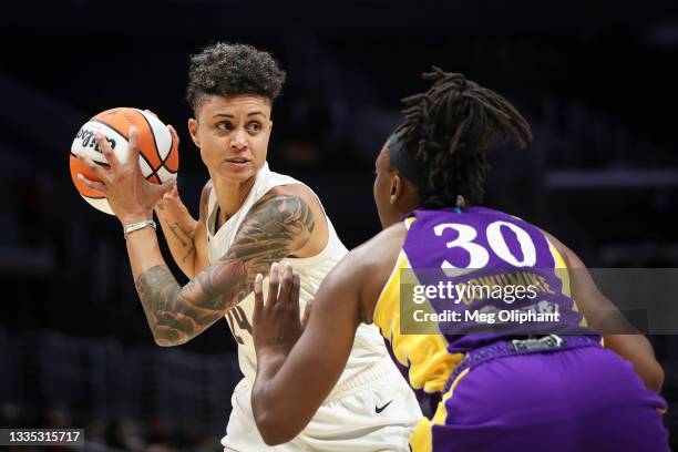 Candice Dupree of the Atlanta Dream looks to pass around Nneka Ogwumike of the Los Angeles Sparks in the first half at Staples Center on August 19,...