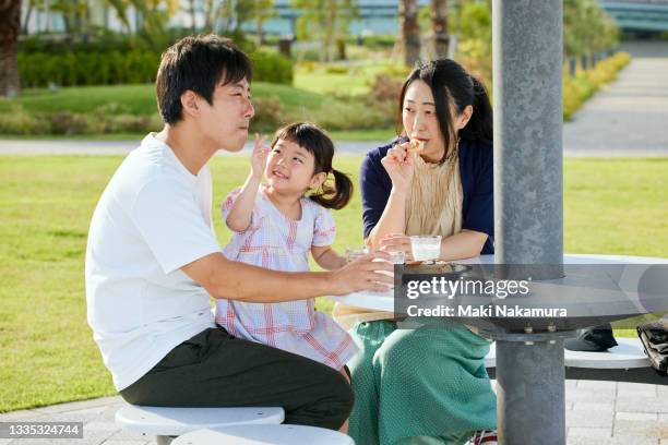 new family having breakfast outdoors - waterfront cafe stock pictures, royalty-free photos & images