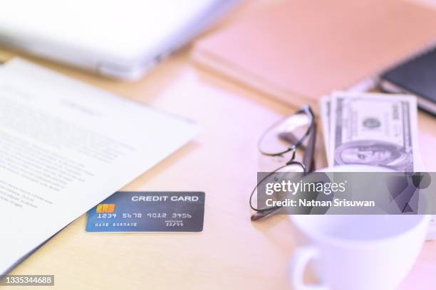 credit card, dollar, eyeglasses, cup of coffee on desk of businessman. - receipt mockup stock pictures, royalty-free photos & images
