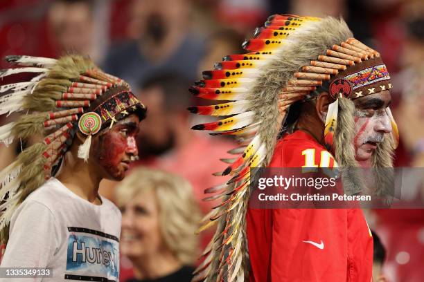 Fans of the Kansas City Chiefs wearing headdresses during the second half of the NFL preseason game against the Arizona Cardinals at State Farm...