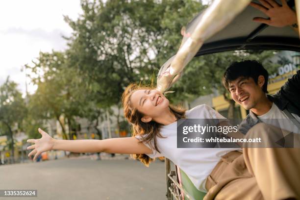 good-humored couples enjoy memorable moments together in a tuk-tuk. - asian and indian ethnicities stockfoto's en -beelden