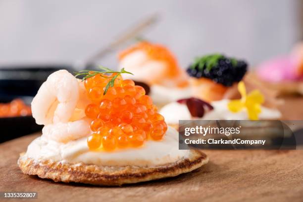 blinis with prawns and caviar. - kaviaar stockfoto's en -beelden