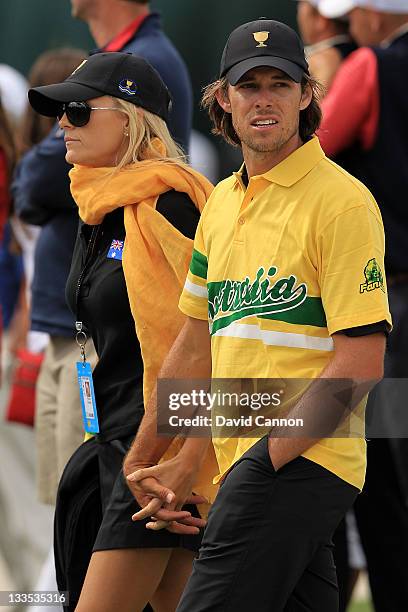 Aaron Baddeley of the International Team and his wife Richelle Baddeley walk together during the Day Four Singles Matches of the 2011 Presidents Cup...