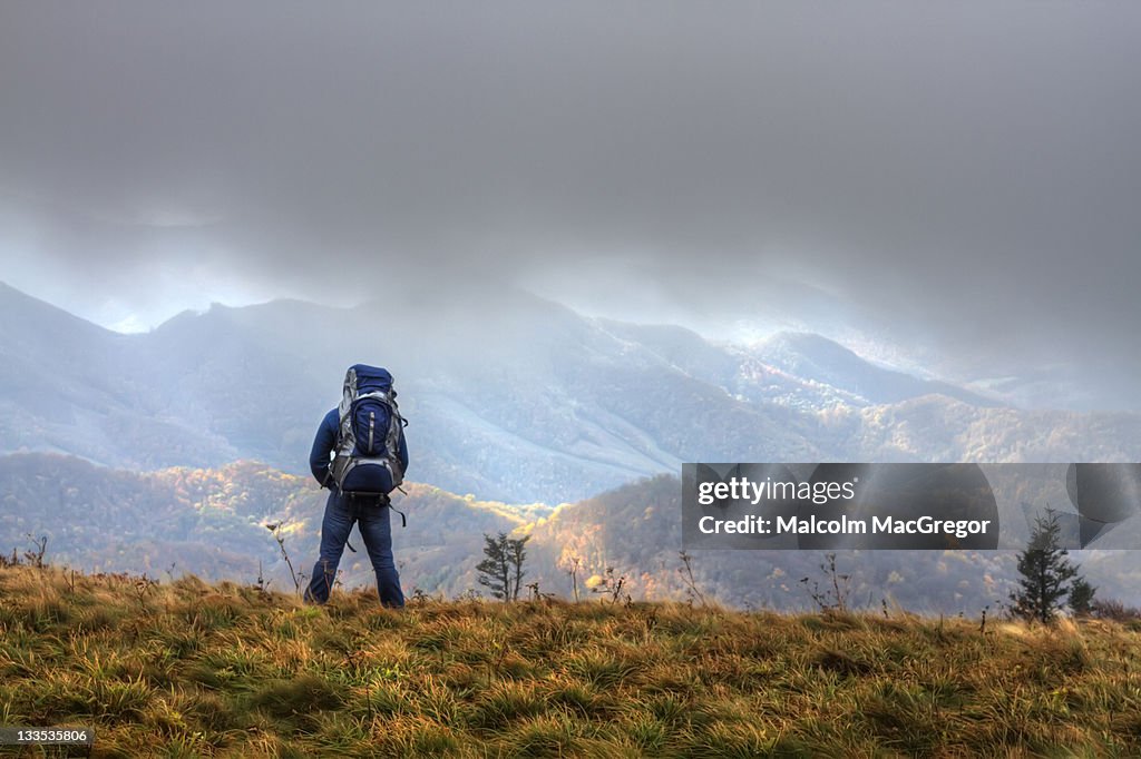 Hiker looking at mountains and valleys