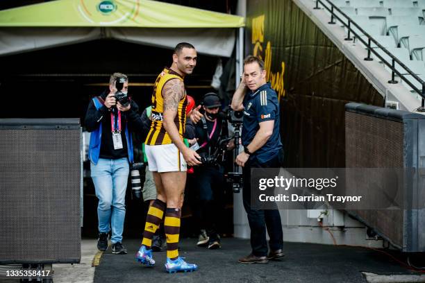 Shaun Burgoyne of the Hawks and Hawthorn Senior coach Alastair Clarkson walk from the M.C.G. After their last game the round 23 AFL match between...