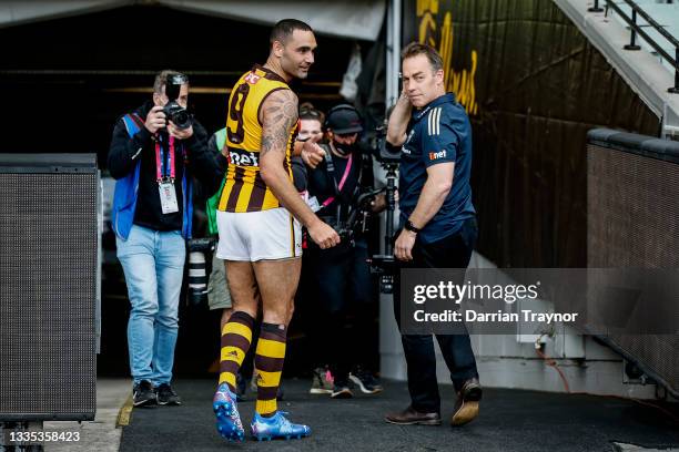 Shaun Burgoyne of the Hawks and Hawthorn Senior coach Alastair Clarkson walk from the M.C.G. After their last game the round 23 AFL match between...