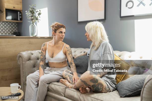 lesbian couple talking on sofa - respect privacy stock pictures, royalty-free photos & images