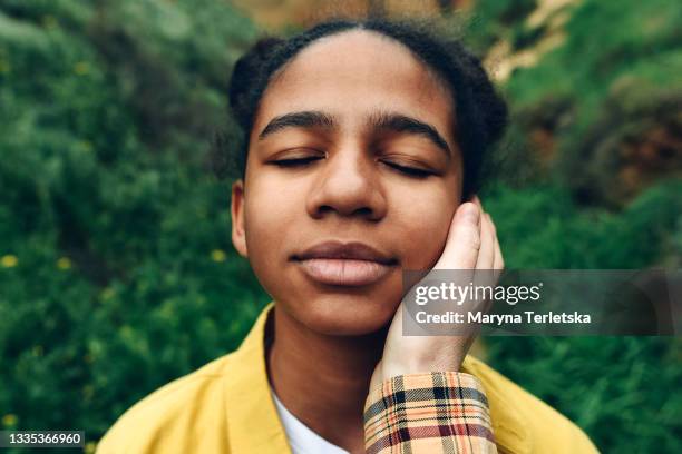 portrait of a dark-skinned girl with closed eyes. - special jurisdiction for peace stock pictures, royalty-free photos & images