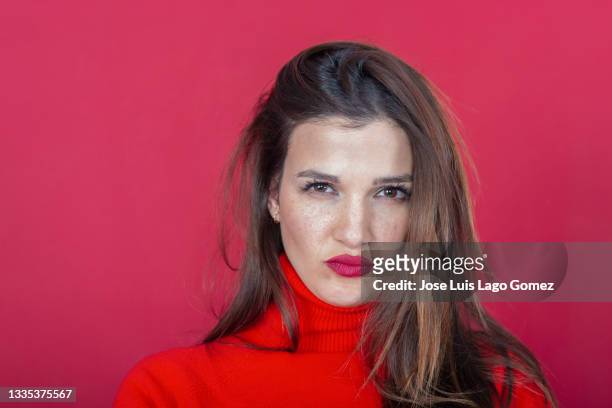 gorgeous young woman with freckles and brown eyes staring straight ahead with a frown - angry woman red stock pictures, royalty-free photos & images