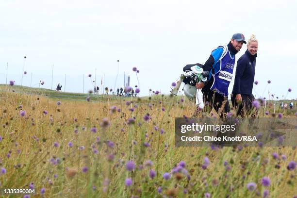 Nicole Broch Larsen of Denmark smiles with her caddie as she walks to play her second shot on the fourth hole during Day Three of the AIG Women's...