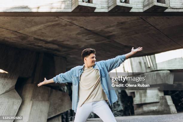 handsome young man spreads his arms in different directions - spread stock pictures, royalty-free photos & images