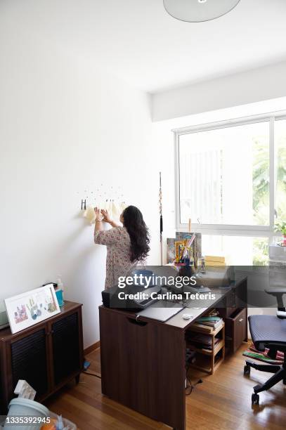 business woman puts up company sign - achievement logo stock pictures, royalty-free photos & images