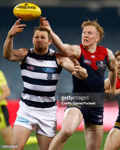 Patrick Dangerfield of the Cats and Clayton Oliver of the Demons contest the ball during the round 23 AFL match between Geelong Cats and Melbourne...