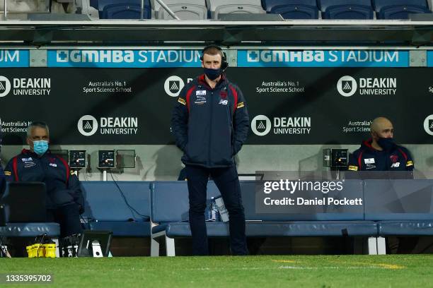 Demons head coach Simon Goodwin looks on along side Demons assistant coach Mark Williams during the round 23 AFL match between Geelong Cats and...