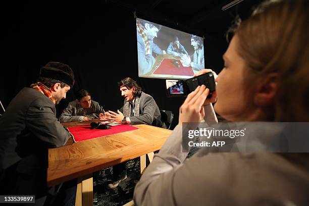 Isabelle WESSELINGH Spectators watch a play called "X Centimetres out of Y Kilometres", directed by Gianina Carbunariu which was premiered this...