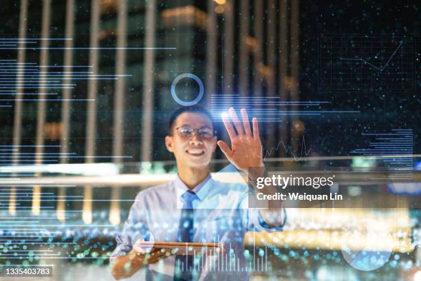 asian man using virtual reality touch screen to view chart data - aprendizaje automático fotografías e imágenes de stock