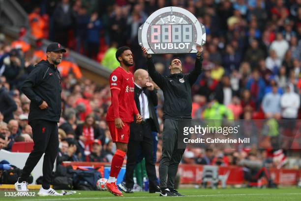 Fourth Official, Andy Madley holds aloft the substitutes board during the Premier League match between Liverpool and Burnley at Anfield on August 21,...
