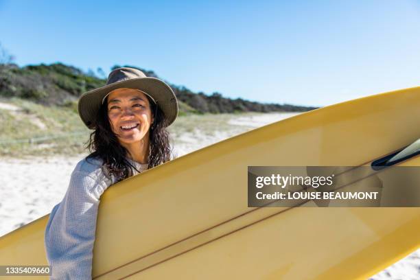 japanese aussie woman excited to surf - australia surfing stock pictures, royalty-free photos & images