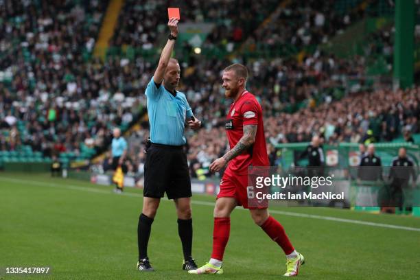 Match Referee, William Collum shows Alan Power of St Mirren a red card during the Cinch Scottish Premiership match between Celtic FC and St. Mirren...