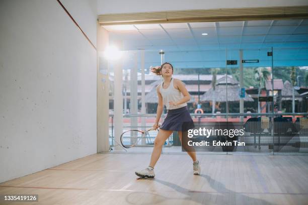 asian chinese teenage girl playing squash alone in the court - daily sport girls bildbanksfoton och bilder