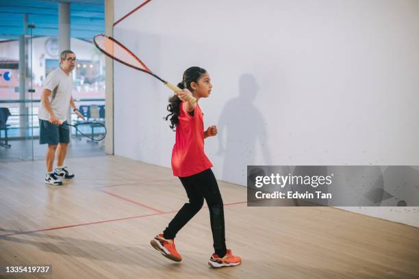 young asian indian female squash player practicing with guidance from her coach - racketball stock pictures, royalty-free photos & images