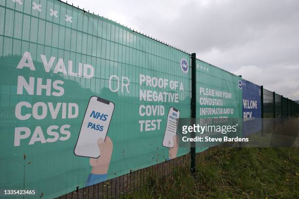 Covid Pass and Negative Covid test advice is seen on a banner outside the stadium prior to the Premier League match between Brighton & Hove Albion...