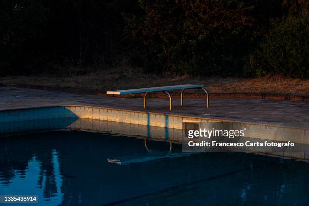 diving board at an empty pool - sports equipment no people stock pictures, royalty-free photos & images