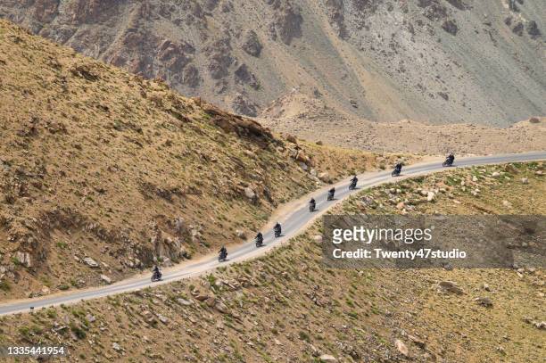 motorcycles touring group driving up to khardung la pass in ladakh, india - car and motorcycle on mountain road stock pictures, royalty-free photos & images