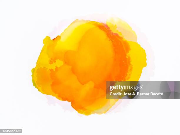 splashes of a drop of yellow paint on a white canvas. - watercolor stockfoto's en -beelden